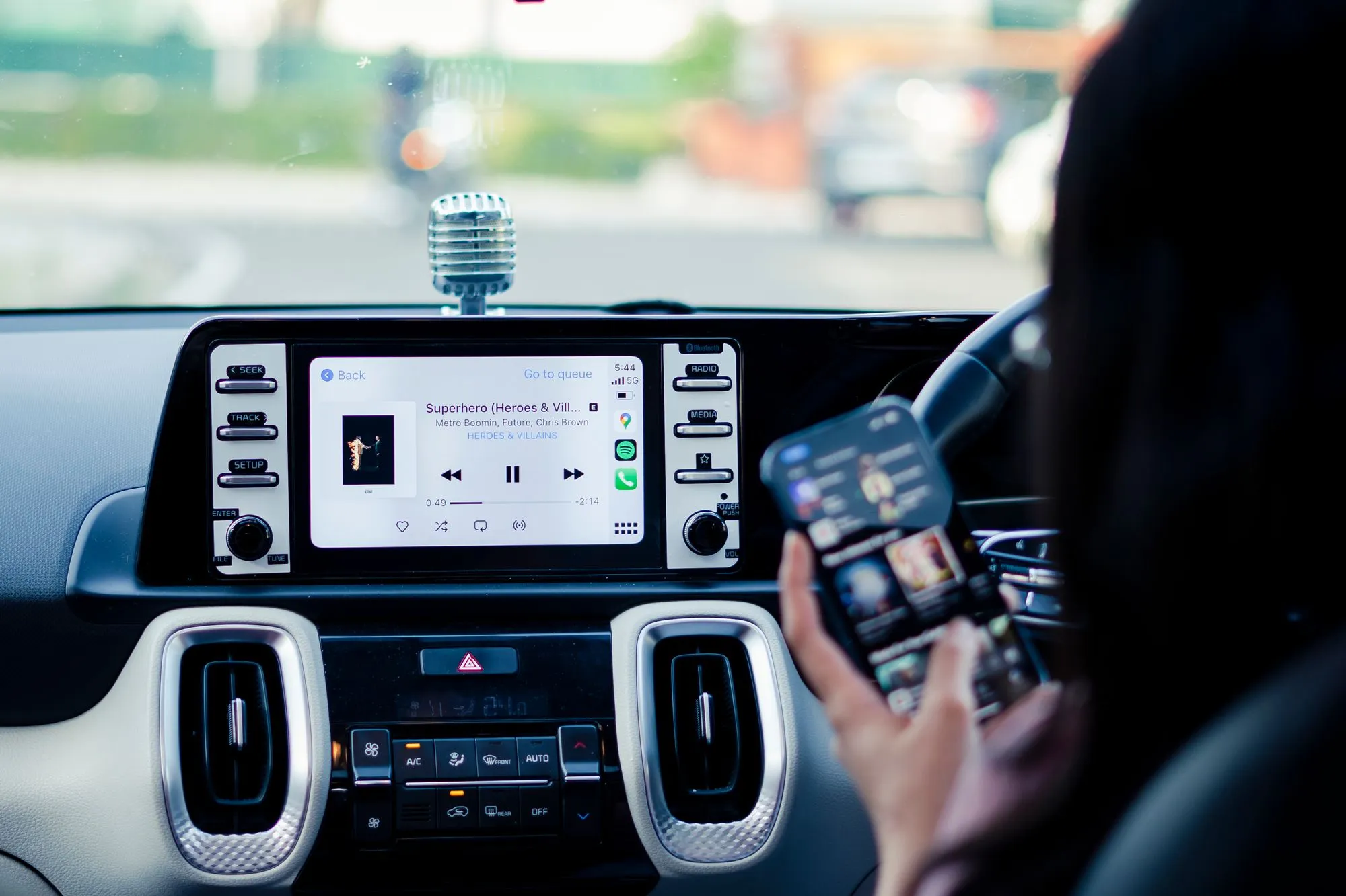 checking the route on a phone from the driver's seat